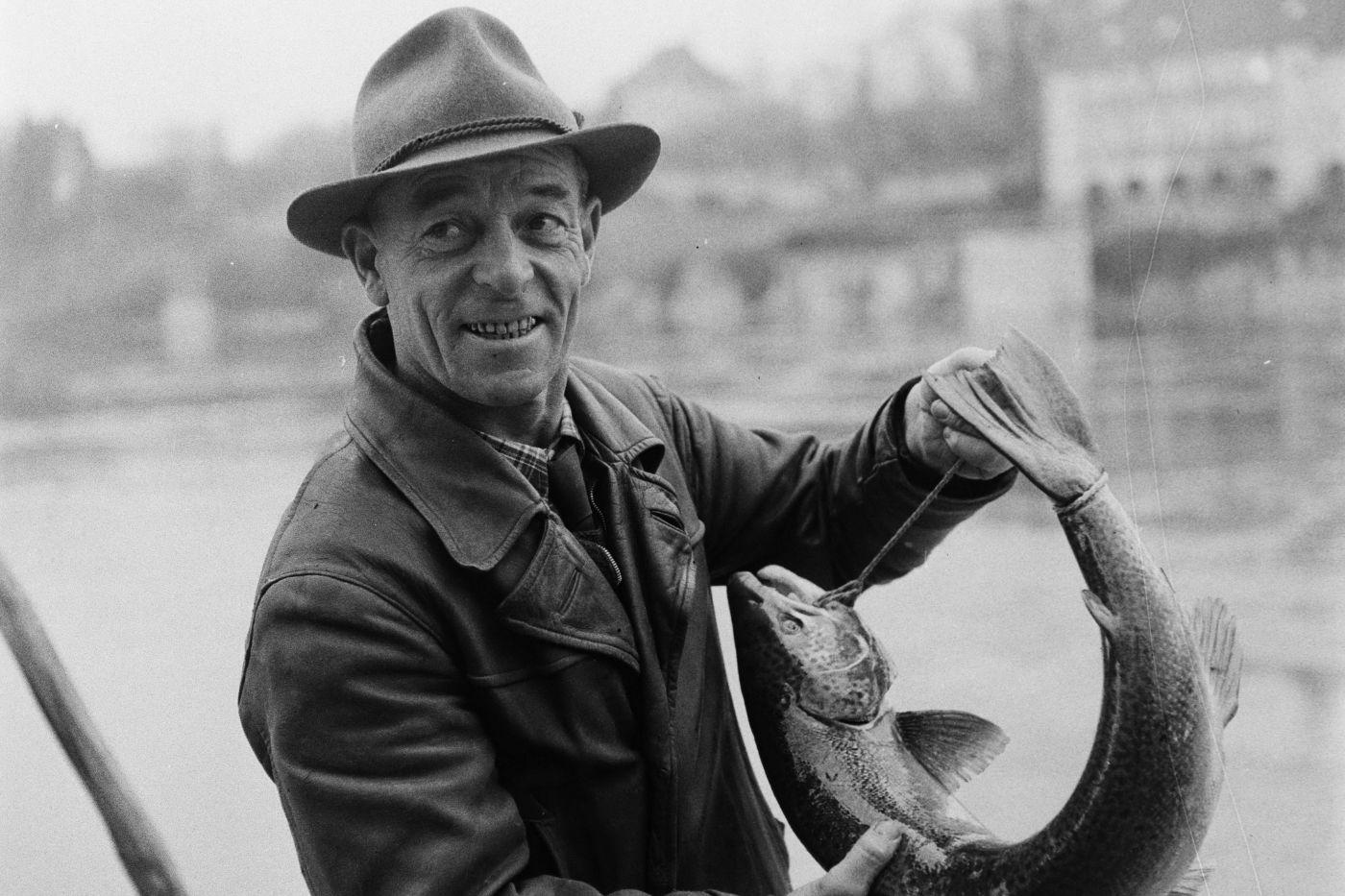 Fischer in Basel präsentiert im Jahr 1945 einen gefangenen Lachs.