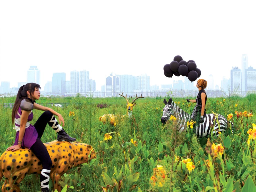 Zwei Cosplayerinnen in einer grünen Wiese. Kunstwerk von Cao Fei.