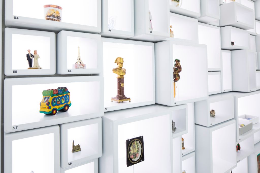 White wall with various souvenirs.